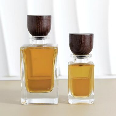 Curved clear glass perfume bottle with natural wooden cap
